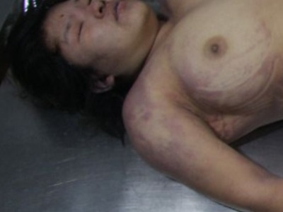 Busty Chinese dead woman laying naked on the morgue table. 