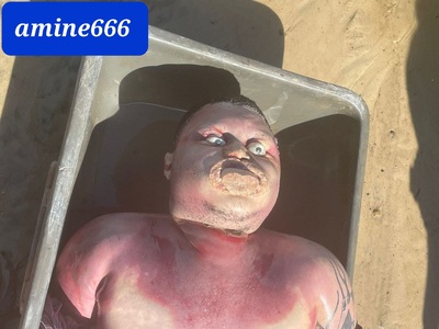 Rotten body of drowned man with his hands tied up and tongue removed