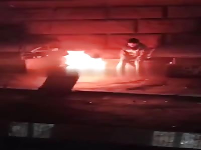 Homeless man burning in the street.