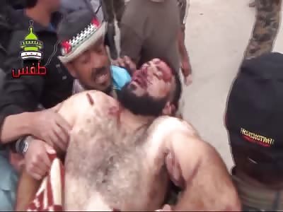 Dead Muslim corpses are picked up and carried through the town.