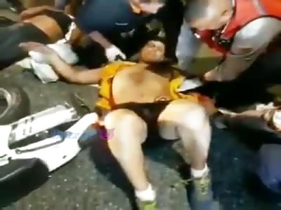 Biker recieves help after traffic accident.