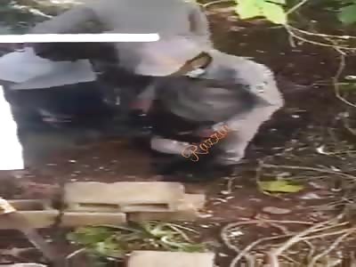 A man is forced to kneel and is shot in the leg.