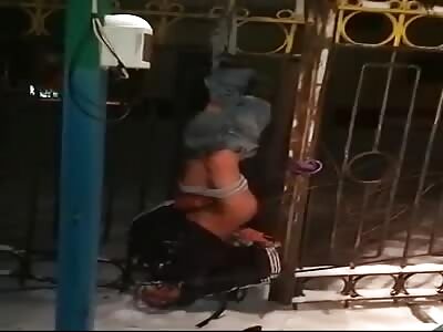 LoL: Drunken Russian hangs half-naked from the fence