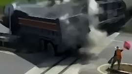 Trucker rammed by train carrying oil tankers