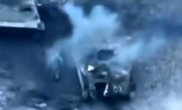 Two Russian soldiers are walking next to a tank when...