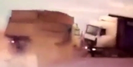 Car caught between two trucks