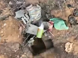 An explosive device is dropped into a Russian dugout