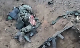 UA troops inside a formerly RU trench, a killed soldier seen