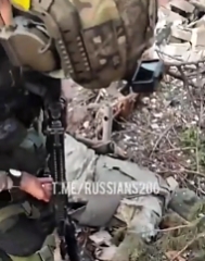 UA soldiers show KIA Russian troops near a building in Bakhmut
