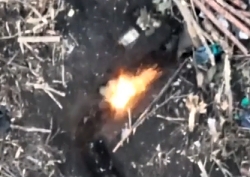 Russian soldier is shooting up at a Ukrainian drone