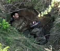 The drone drops several grenades on the RU soldier in the dugout