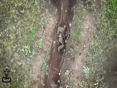 Wounded soldier pushes away the grenades with his hands.