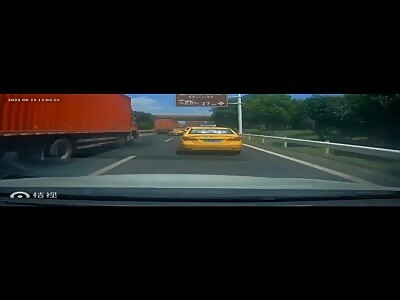 Taxi crushed between two cargo trucks.