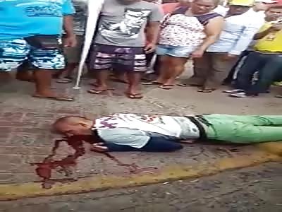 Man dying on the sidewalk after headshot