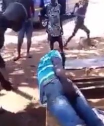 2 Men Accused of Stealing being Whipped in the Ass