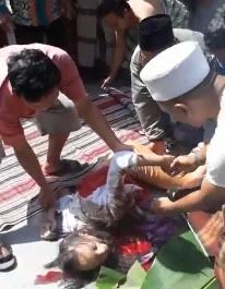 Crushed woman is removed from the road..Gruesome Scene 