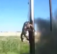 Corpse Roasting over a Fire like a Pig... Hung from a Wire Pole 
