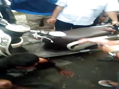 Your Right in the Action as a Thief is Beaten with Everything including his Own Scooter 