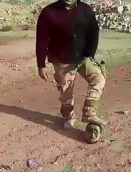 Man walks among the Dead and Poses with Severed heads 