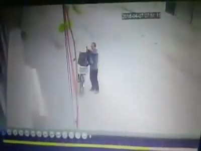 Guy Locking his Bicycle up on a Pole is Hit by Car