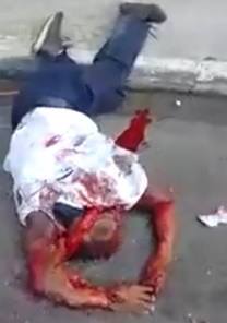 Man killed by Out of ontrol Bus lies in the Street like Road kill.  Many Gather to see it 