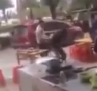 Crying Man Beaten over the Head with Pots and Pans in Front a Restaurant