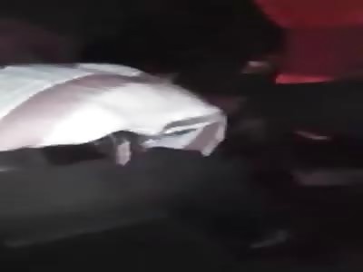 Man in Despair Holds His Dead Son with Head Crushed by Truck