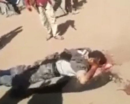 Man Being Machine Gun Executed in Front of Crowd