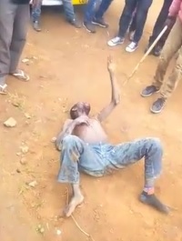 Stunned Thief Beaten by Angry Crowd .