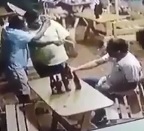 Fat Dude in Yellow Shoots Guy Sitting then Carries on Conversation