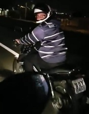 One Last Ride for a Biker Doing Wheelie on Road
