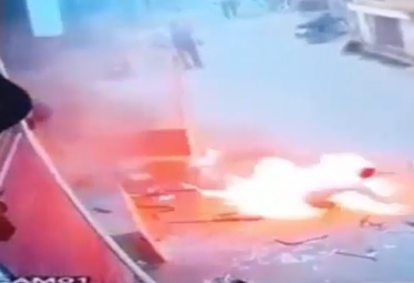 Explosion in Store Sends Burning Man Flying Out.