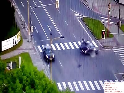 Biker gets some air and spins after hitting car