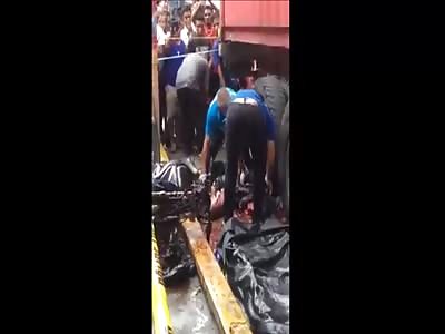 Removing The Body Of A Motorcyclist Crushed By A Truck