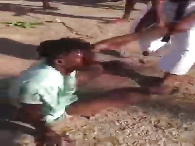 Two African men being beaten.