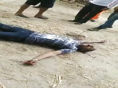 MAN DYING IN AGONY AND PEOPLE PRAYING AROUND HIM