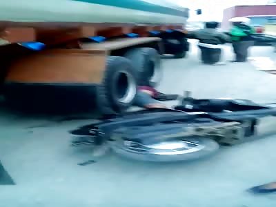 MOTORCYCLE REMAINS UNDER THE TRUCK RIMS