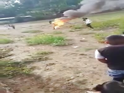 Man on fire running across the field