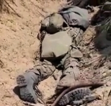 Ukrainian soldier steps over bodies of RU troops