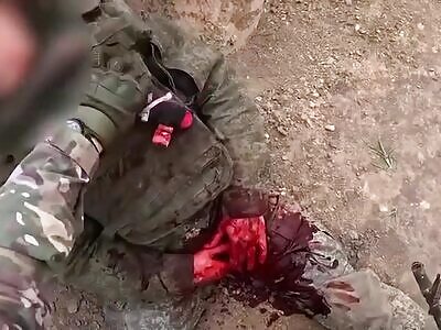 Dead Russian inspected by Ukrainian Soldier