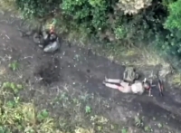 UA drone panning over multiple RU casualties in a forested area