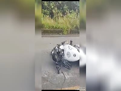 traffic incident with dead motorcyclists crushed under big truck 