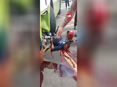 Motorcyclist dies after being crushed by 