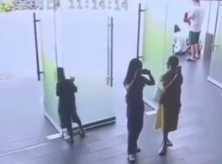 Little boy have his head trapped between two glass doors 