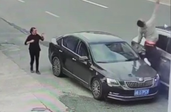 Driver twisted between two cars 