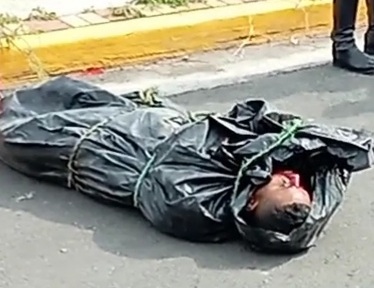 Dead corps of gang member bagged and dumped on road 