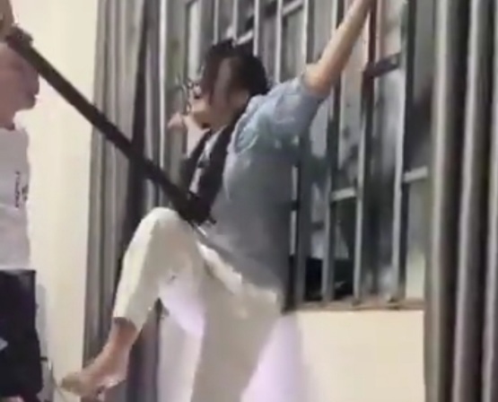 Girl Tied to a Window Bars and Tortured by Electric Baton.