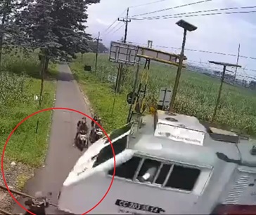 Watch The Horrific Moment When Distracted Woman is Annihilated by Train In Indonesia.