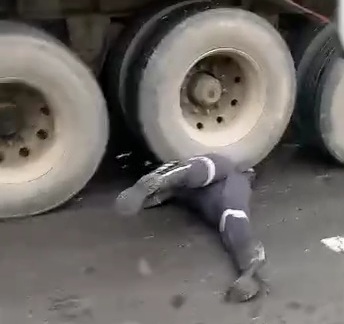 Motorcyclist crashed under big loaded truck 