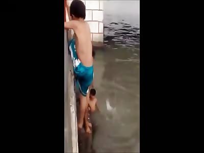 Blue Shorts Kid Drowns in the River by Taking up Friend's Challenge to Jump